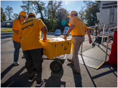 Disaster relief volunteers carrying supplies